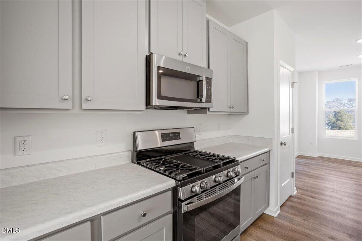 443 North Fisher Street Raleigh, NC 27610 - Photo 16 of 33 a kitchen with microwave cabinets and stove top oven