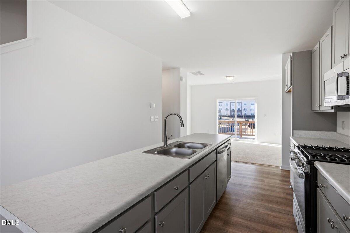 443 North Fisher Street Raleigh, NC 27610 - Photo 18 of 33 a kitchen with a sink and a stove