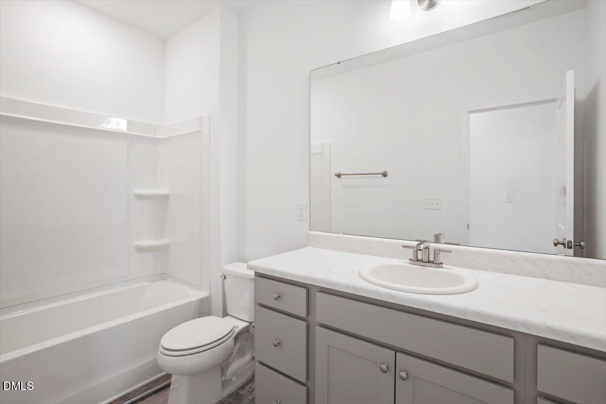 443 North Fisher Street Raleigh, NC 27610 - Photo 27 of 33 a bathroom with a sink toilet a bathtub and vanity