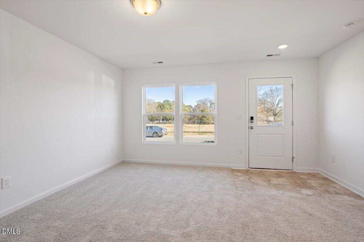 443 North Fisher Street Raleigh, NC 27610 - Photo 7 of 33 an empty room with windows