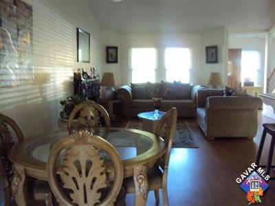 42339 Blossom Drive Lancaster, CA 93536 - Photo 3 of 8 a living room with furniture and a chandelier