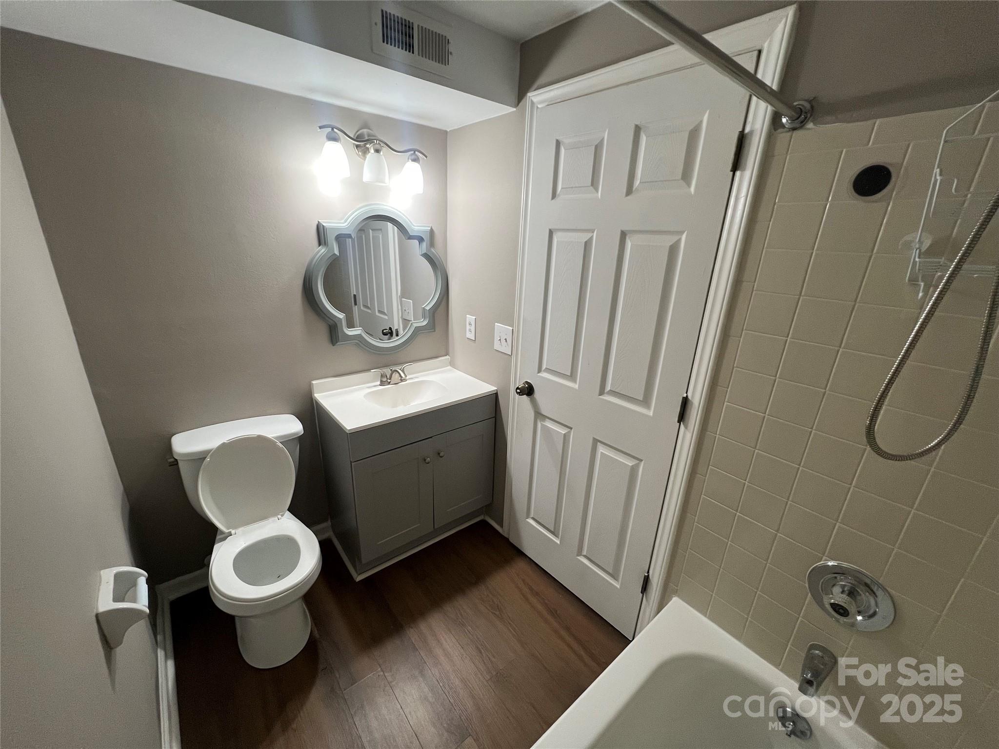 9401 Old Concord Road, Unit K Charlotte, NC 28213 - Photo 8 of 12 a bathroom with a toilet sink and mirror