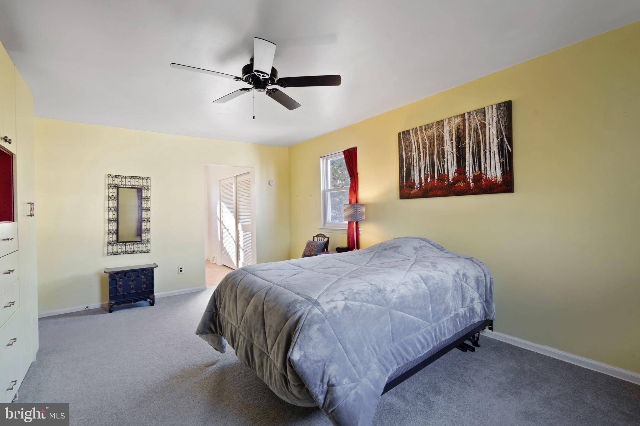 303 Highland Road Cheltenham, PA 19012 - Photo 14 of 25 a bedroom with a bed and a chandelier