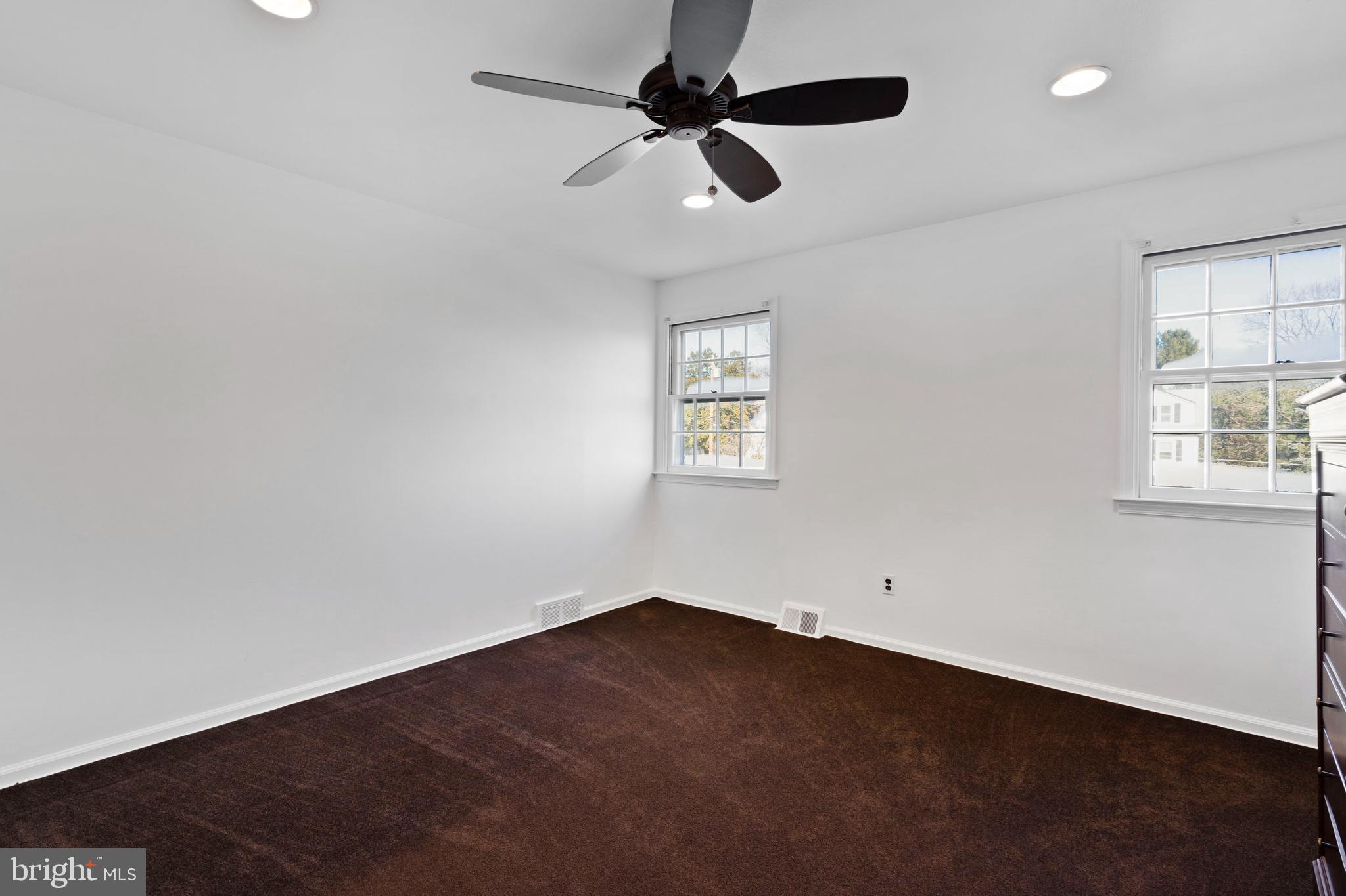303 Highland Road Cheltenham, PA 19012 - Photo 17 of 25 an empty room with a window and a fan