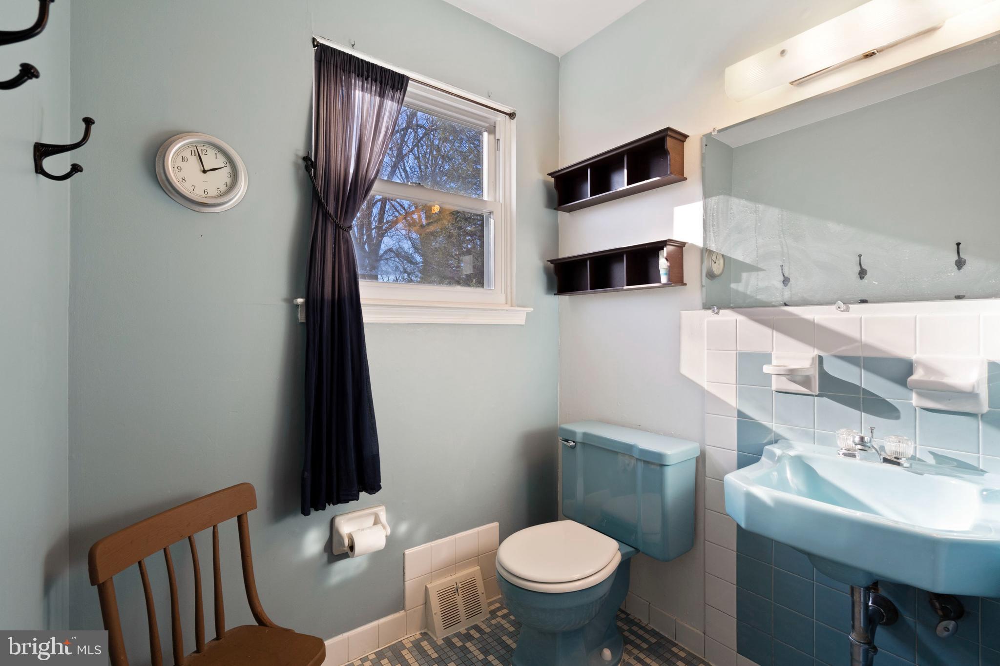 303 Highland Road Cheltenham, PA 19012 - Photo 18 of 25 a bathroom with a toilet a sink and mirror