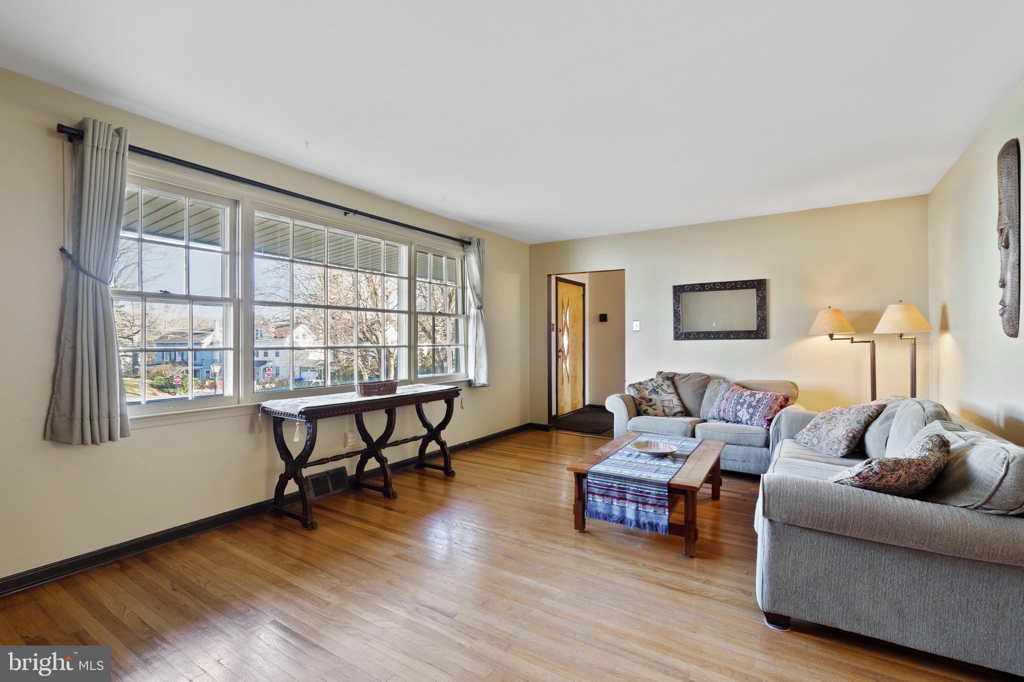 303 Highland Road Cheltenham, PA 19012 - Photo 2 of 25 a living room with furniture and a wooden floor