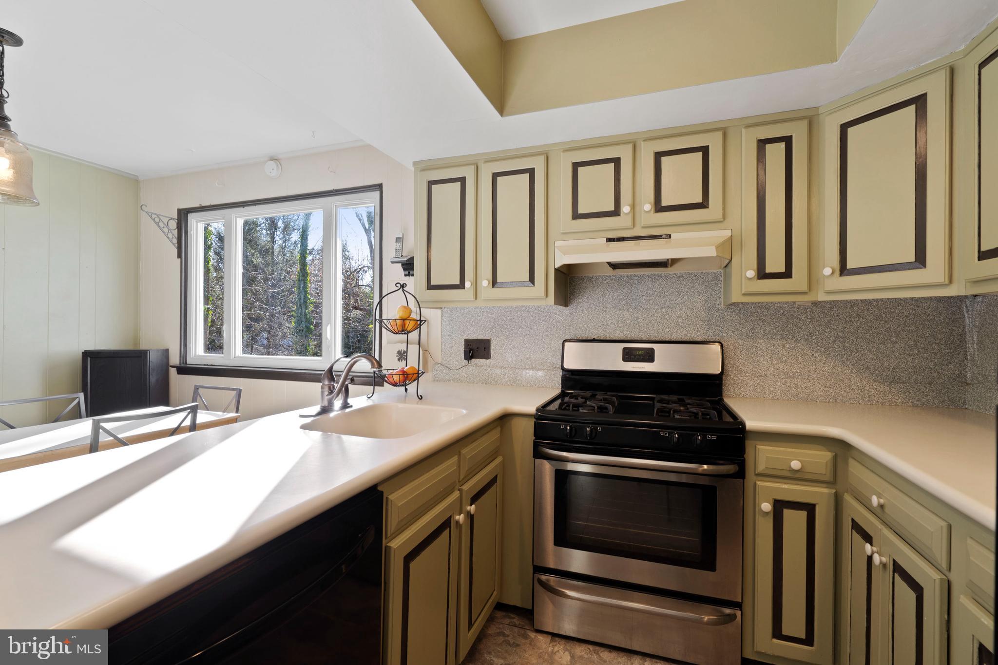 303 Highland Road Cheltenham, PA 19012 - Photo 6 of 25 a kitchen with a sink stove and microwave