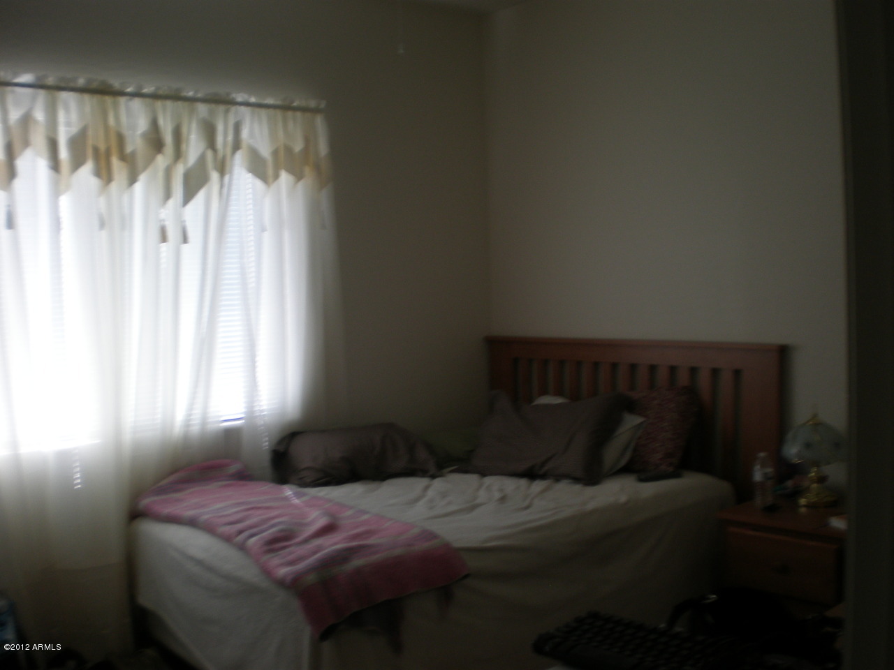 2300 East Magma Road San Tan Valley, AZ 85143 - Photo 6 of 10 a bedroom with a bed and a window