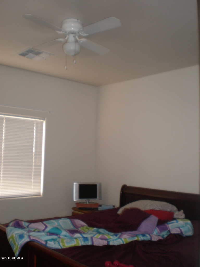 2300 East Magma Road San Tan Valley, AZ 85143 - Photo 7 of 10 a bedroom with a bed and a window