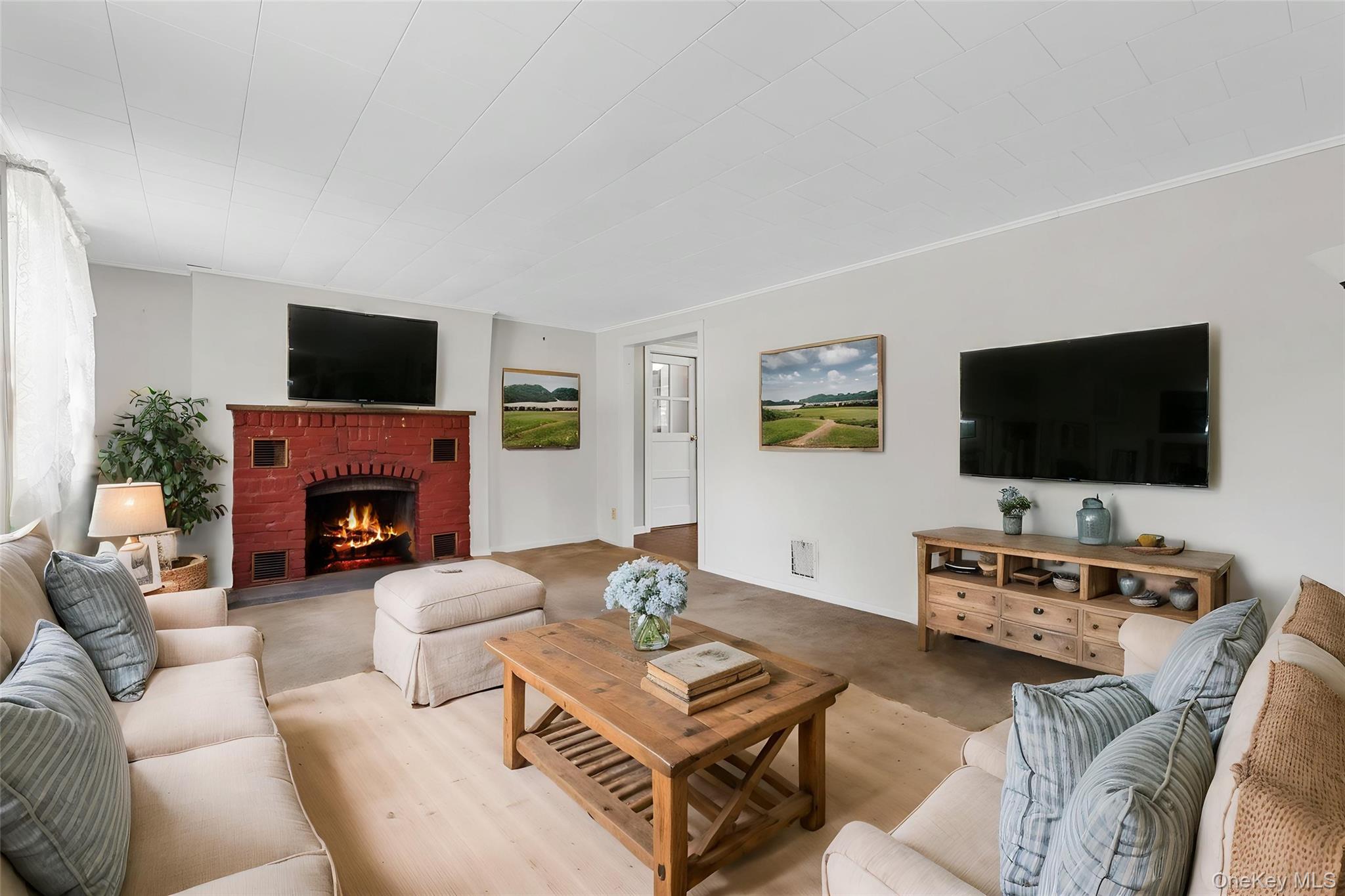 89 Brown Road Wappingers Falls, NY 12590 - Photo 6 of 19 a living room with furniture a flat screen tv and a fireplace