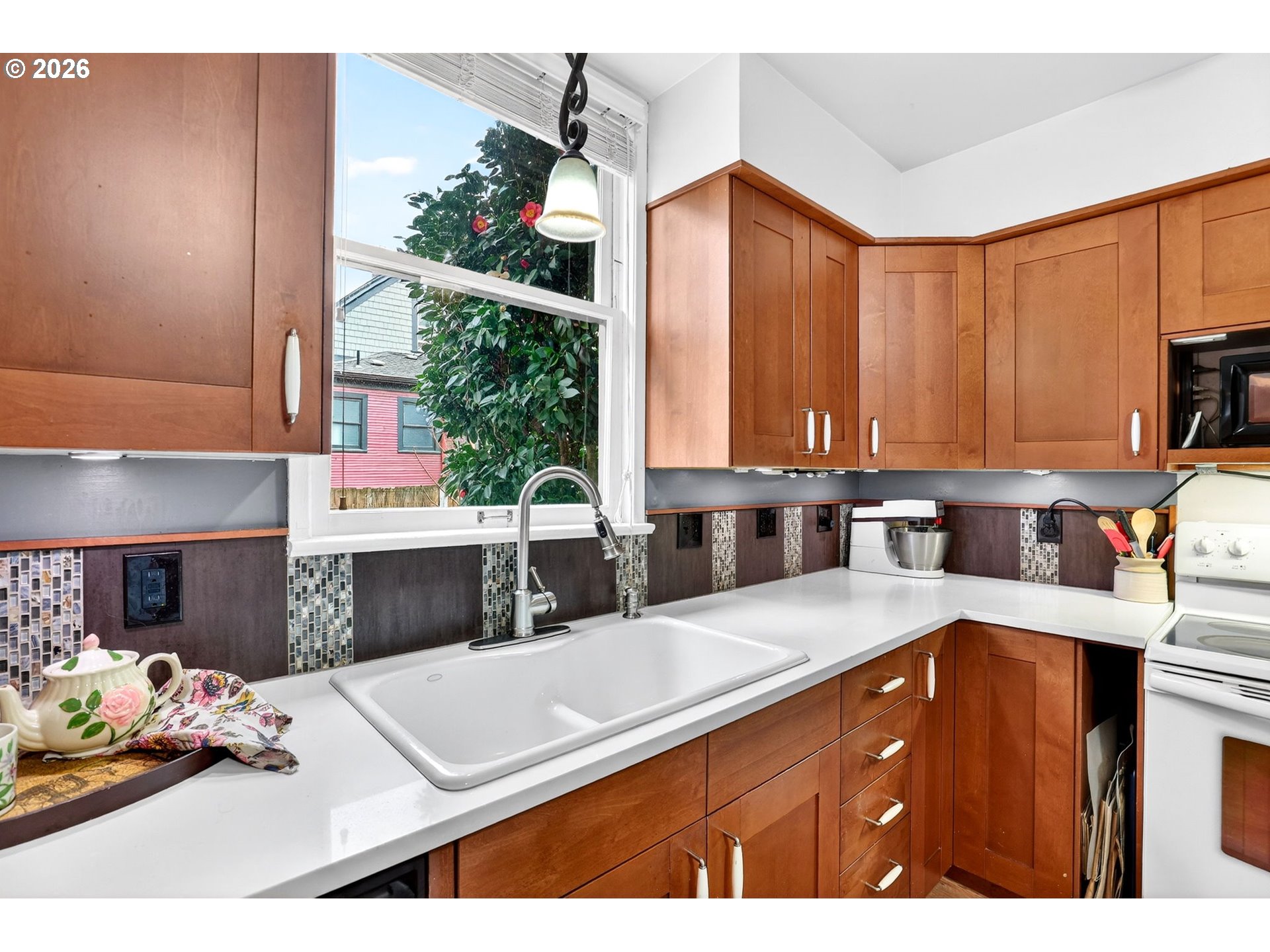 2820 Northeast Oregon Street Portland, OR 97232 - Photo 14 of 41 a kitchen with kitchen island granite countertop a sink cabinets and window