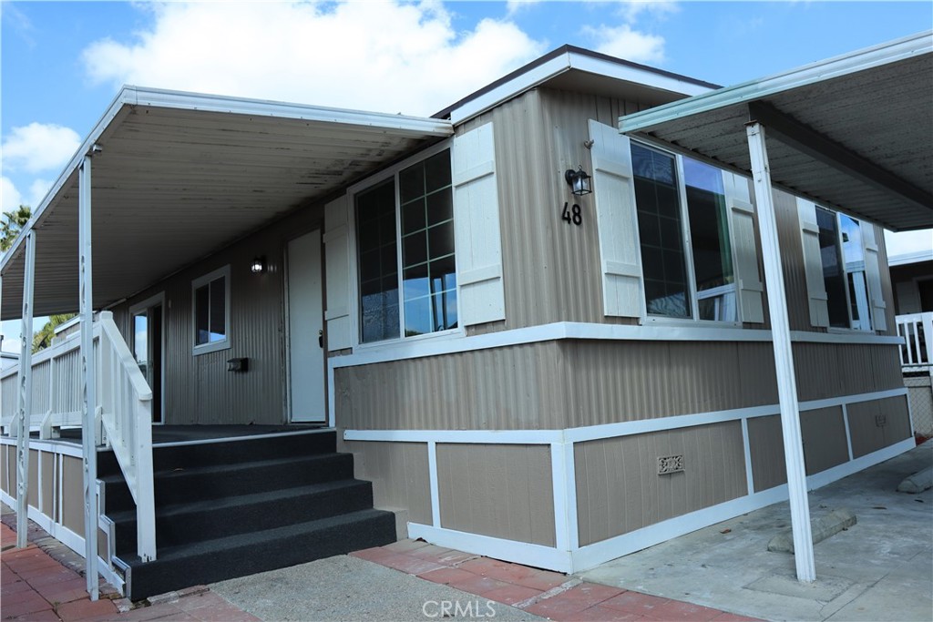 1855 East Riverside Drive, Unit 48 Ontario, CA 91761 - Photo 1 of 20 a view of staircase with white walls and a window