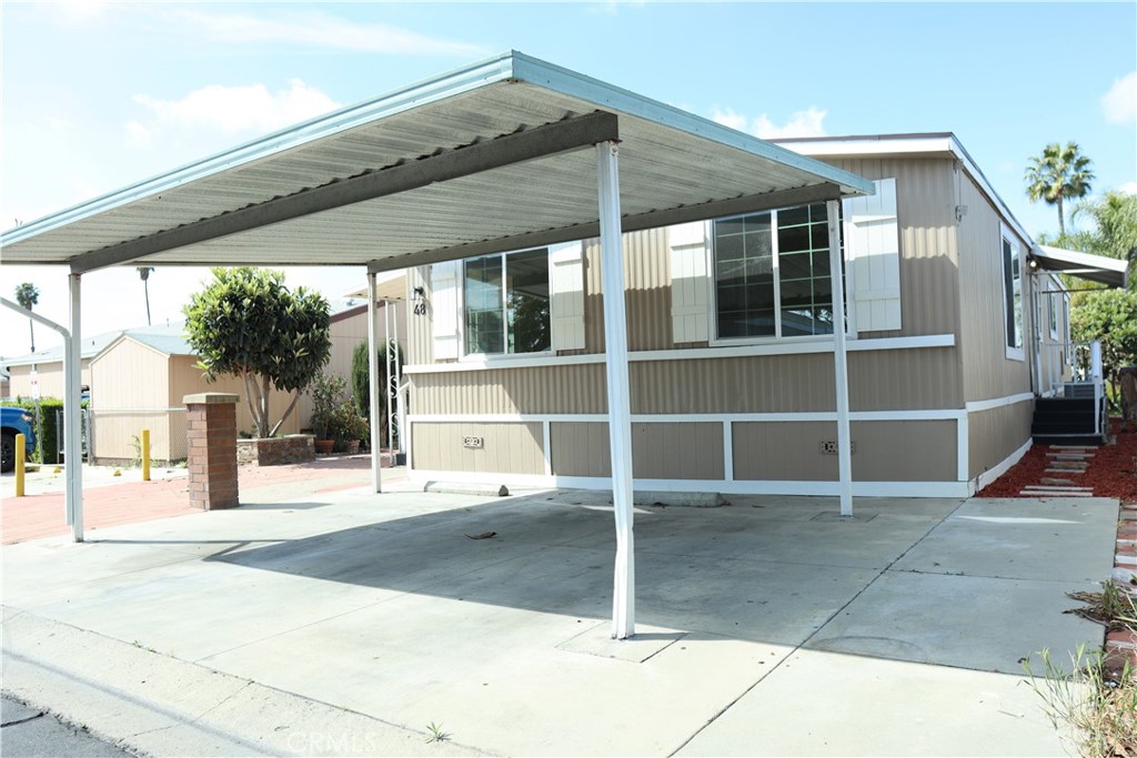 1855 East Riverside Drive, Unit 48 Ontario, CA 91761 - Photo 3 of 20 a front view of a house with a garage