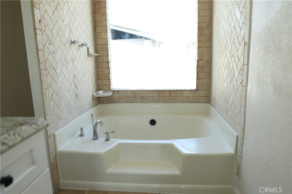1855 East Riverside Drive, Unit 48 Ontario, CA 91761 - Photo 8 of 20 a bathroom with a bathtub and shower