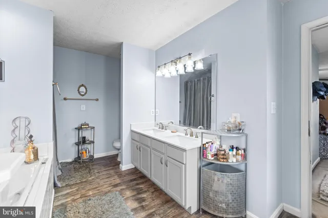 a bathroom with a double vanity sink mirror and shower