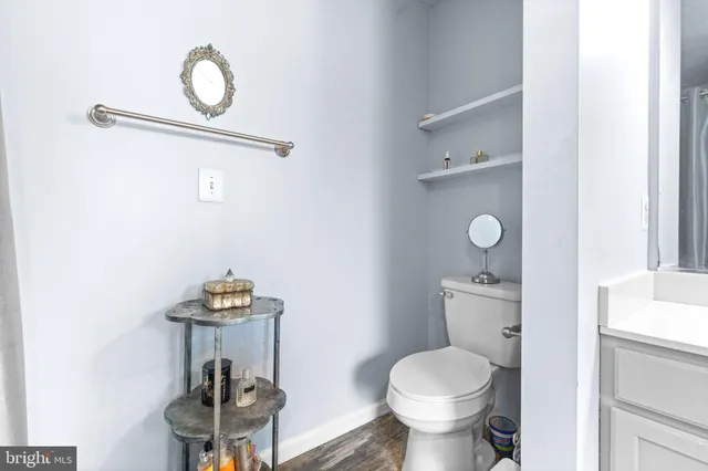 a bathroom with a toilet sink and mirror