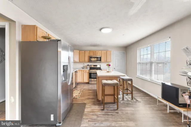 a view of a kitchen with dining table and chairs