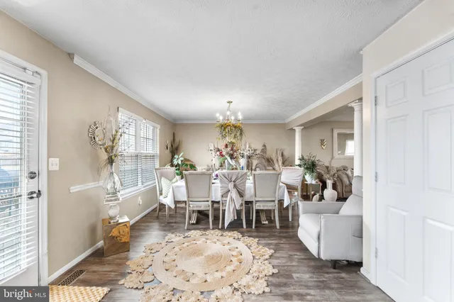 a view of a dining room with furniture window and wooden floor