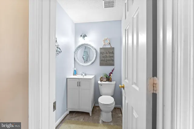 a bathroom with a toilet a sink and a mirror
