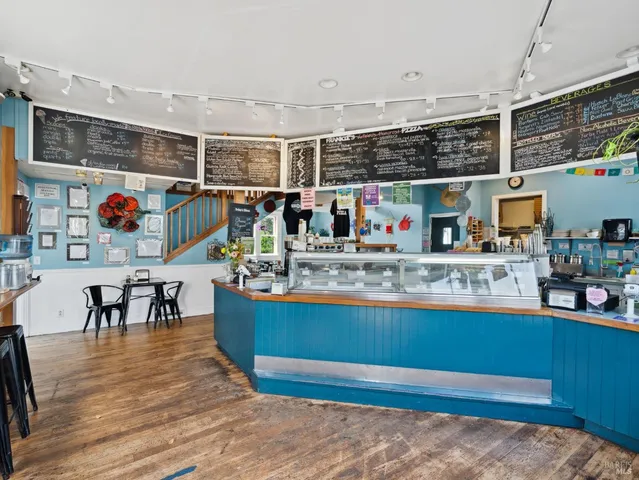 a view of a dining room with furniture and window