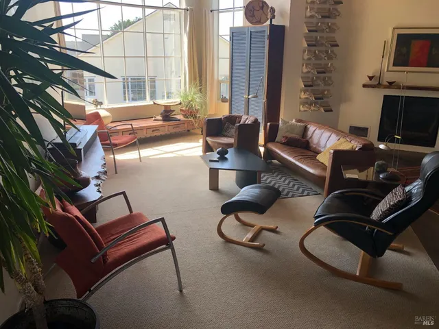 a view of a livingroom with furniture and a window