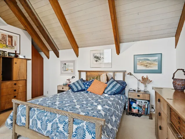 a bedroom with furniture and wooden floor