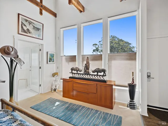 a view of a house with a small yard and wooden fence