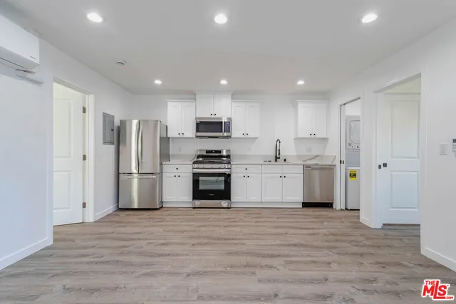 a kitchen with stainless steel appliances a refrigerator and a stove top oven