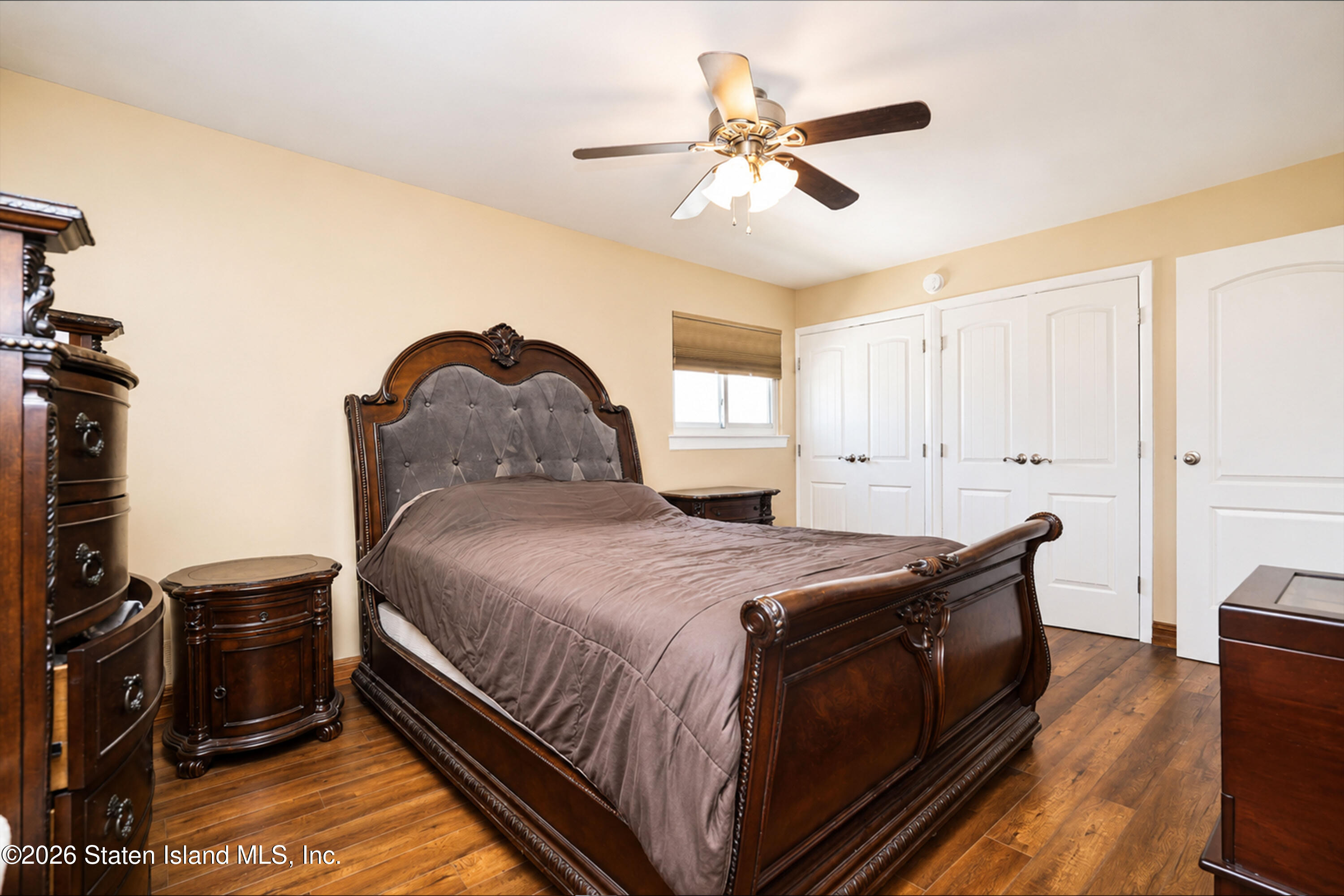 37 Middle Loop Road Staten Island, NY 10308 - Photo 20 of 38 a bedroom with a bed and a chandelier