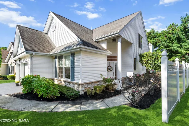 a front view of house with a garden