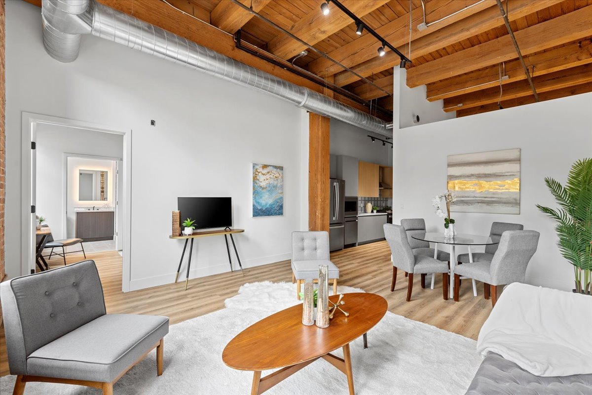 153 West Ohio Street, Unit 202 Chicago, IL 60654 - Photo 2 of 11 a living room with furniture and a flat screen tv