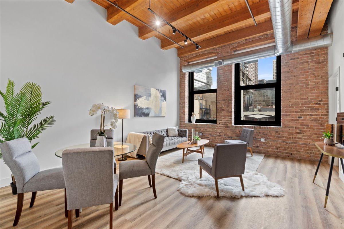 153 West Ohio Street, Unit 202 Chicago, IL 60654 - Photo 4 of 11 a dining room with furniture and window