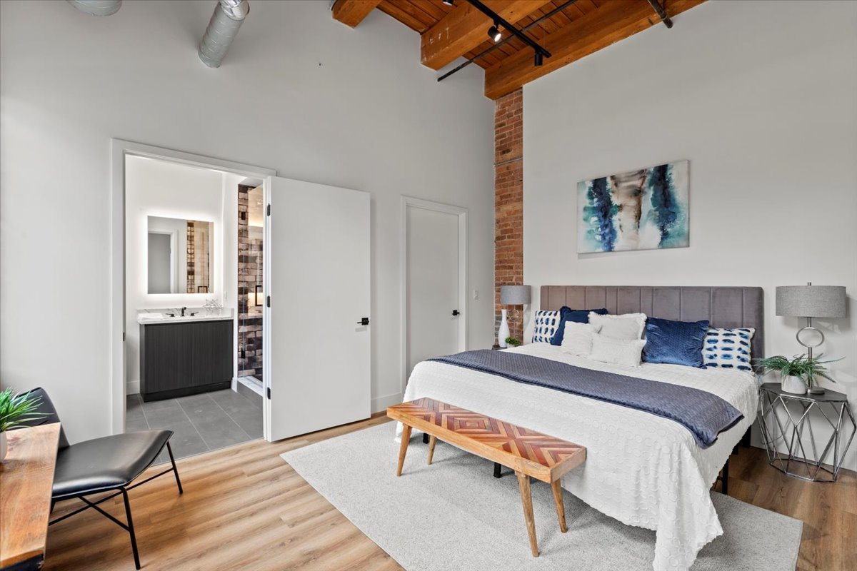 153 West Ohio Street, Unit 202 Chicago, IL 60654 - Photo 5 of 11 a bedroom with a bed and a table in it