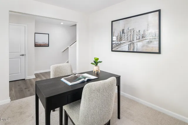 a living room with stainless steel appliances furniture dining table and wooden floor