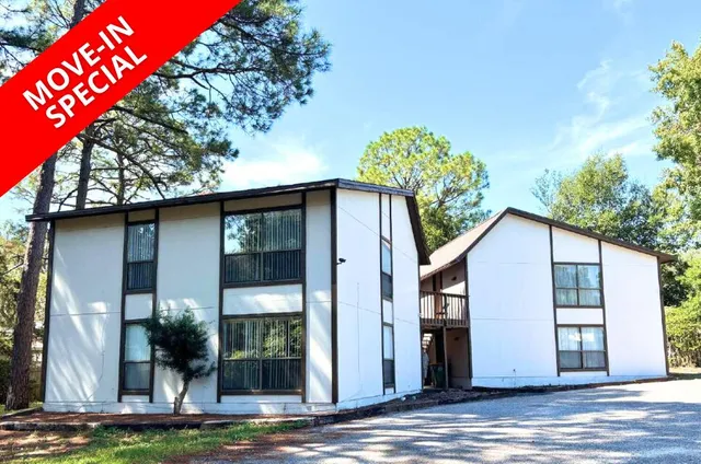 a house that has a tree in front of it