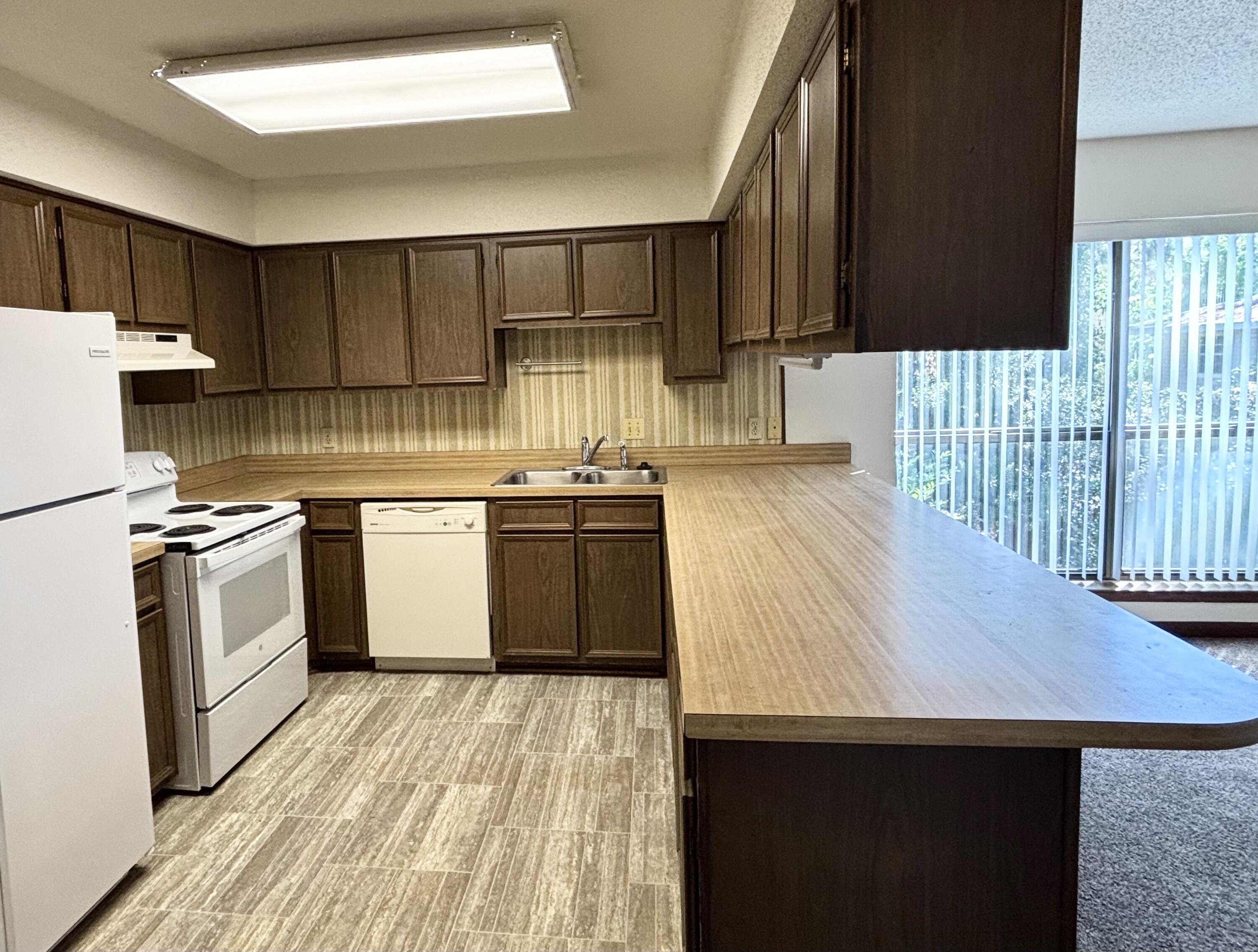 337 Lewis Street, Unit F Fort Walton Beach, FL 32547 - Photo 3 of 10 a kitchen with a sink a stove a refrigerator and cabinetry