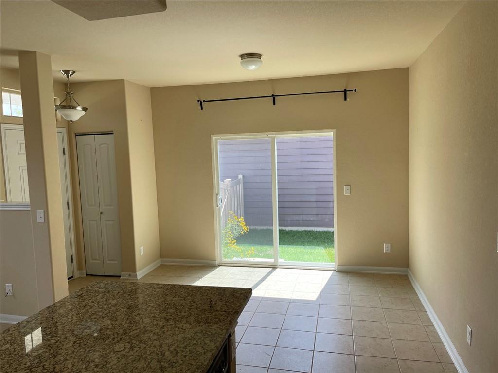 1420 Nevarez Kyle, TX 78640 - Photo 4 of 9 A well-lit dining area offers direct outdoor access through sliding glass doors.