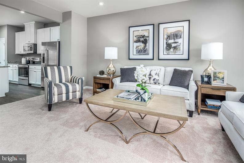 7920 Mine Run Road, Unit MOZART Hanover, MD 21076 - Photo 10 of 27 a living room with furniture and kitchen view