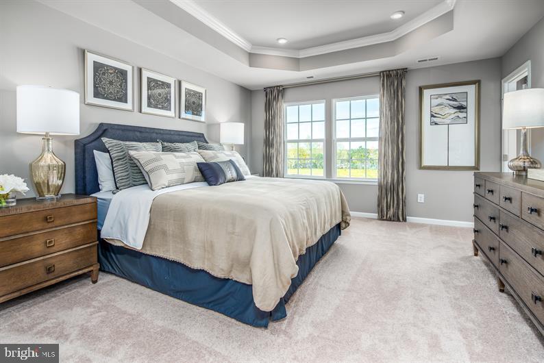 7920 Mine Run Road, Unit MOZART Hanover, MD 21076 - Photo 11 of 27 a bedroom with a bed and a dresser