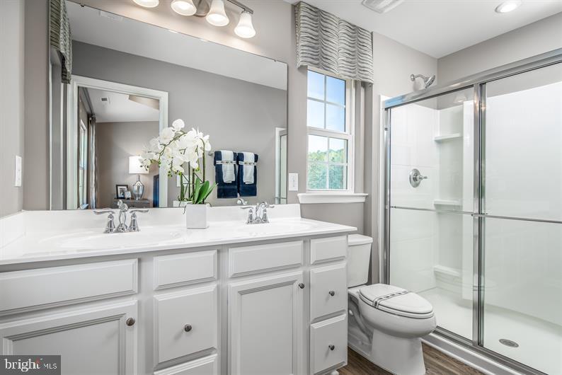 7920 Mine Run Road, Unit MOZART Hanover, MD 21076 - Photo 14 of 27 a bathroom with a sink toilet and shower