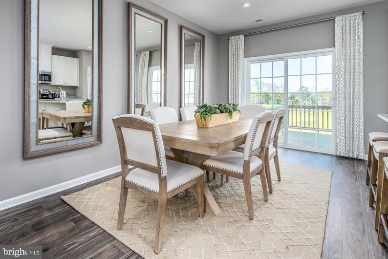 7920 Mine Run Road, Unit MOZART Hanover, MD 21076 - Photo 6 of 27 a view of a dining room with furniture and wooden floor