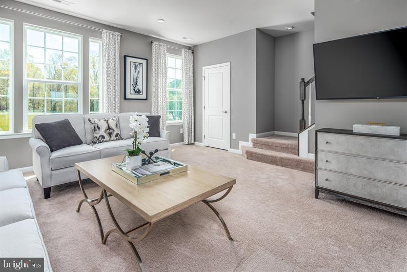7920 Mine Run Road, Unit MOZART Hanover, MD 21076 - Photo 9 of 27 a living room with furniture and a flat screen tv