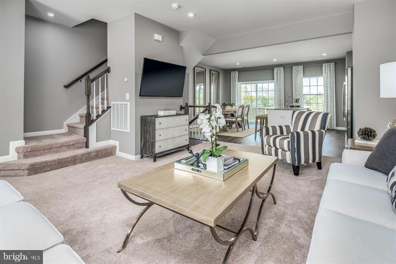 7920 Mine Run Road, Unit MOZART Hanover, MD 21076 - Photo 27 of 27 a living room with fireplace furniture and a flat screen tv