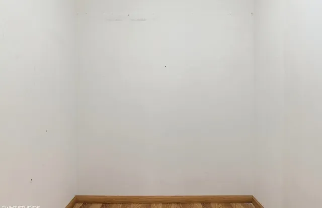 an empty room with windows and closet