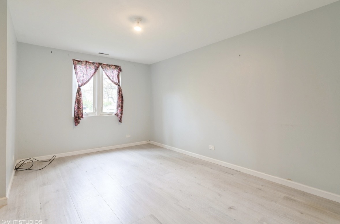 1525 Sander Court, Unit 113 Wheeling, IL 60090 - Photo 13 of 22 an empty room with windows and closet