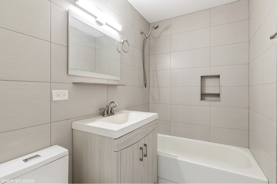 1525 Sander Court, Unit 113 Wheeling, IL 60090 - Photo 14 of 22 a bathroom with a sink a toilet and bathtub