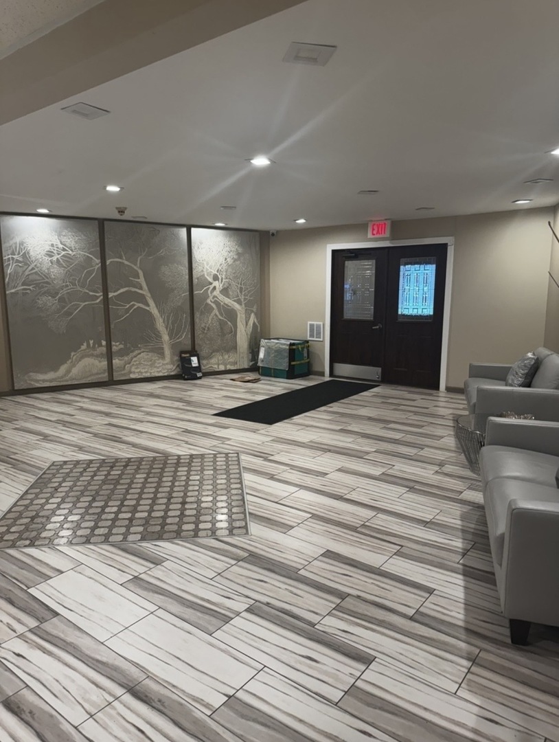 1525 Sander Court, Unit 113 Wheeling, IL 60090 - Photo 17 of 22 a bedroom with a bed and a night stand