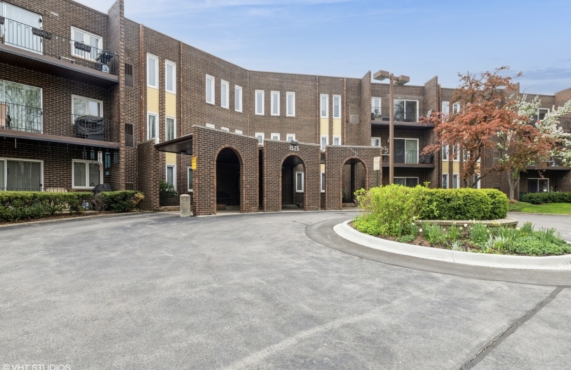 1525 Sander Court, Unit 113 Wheeling, IL 60090 - Photo 2 of 22 a view of a building with a garden