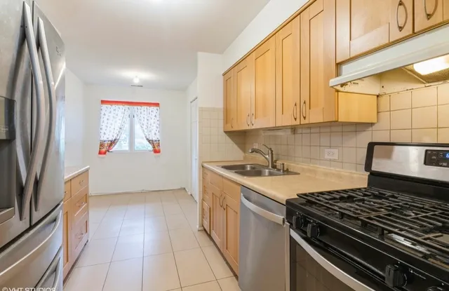 a kitchen with granite countertop white cabinets and sink