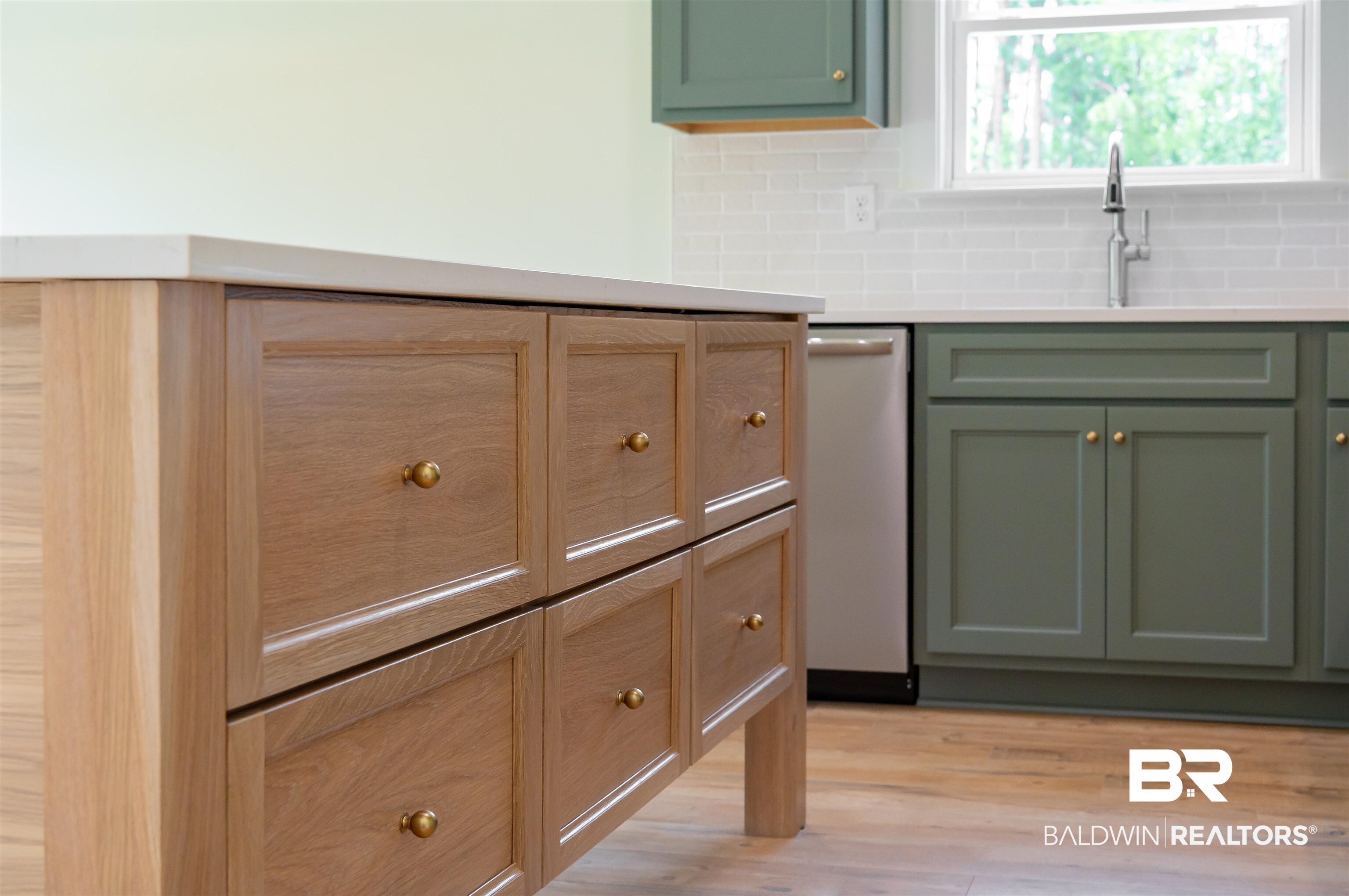 657 Island Way Gulf Shores, AL 36542 - Photo 6 of 59 Kitchen with green cabinetry, stainless steel dishwasher, decorative backsplash, and light countertops